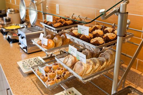 a bakery with various pastries and breads on a counter at SpringHill Suites Wenatchee in Wenatchee