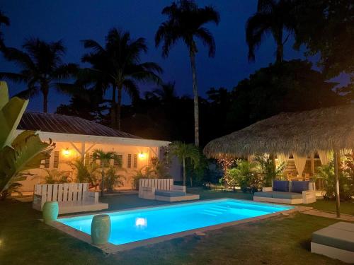 a villa with a swimming pool at night at PUNTA POPY Boutique HOTEL in Las Terrenas