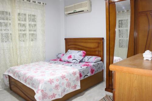 a small bedroom with a bed and a dresser at Entire rental unit in New Cairo, Egypt in Cairo