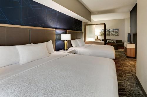 a hotel room with two beds and a living room at SpringHill Suites Dayton South/Miamisburg in Miamisburg