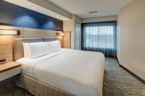 a hotel room with a bed and a window at SpringHill Suites Dayton South/Miamisburg in Miamisburg