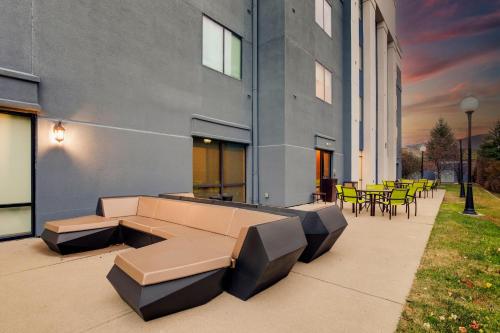 a patio with a couch and tables and chairs at SpringHill Suites Dayton South/Miamisburg in Miamisburg