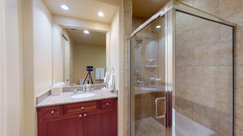 a bathroom with two sinks and a glass shower at LV028 Private Downstairs Studio on Main Paseo in La Quinta