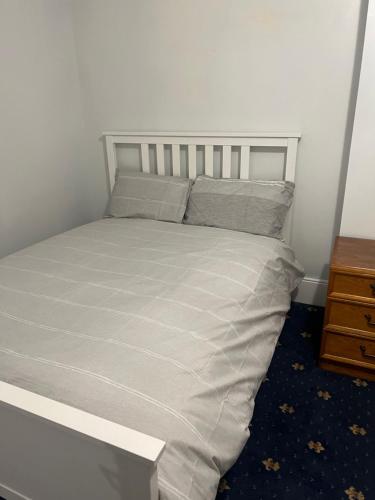 a bed in a bedroom with a white bed frame at La Vera in South Norwood
