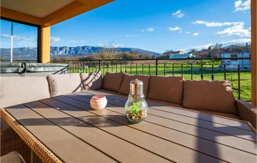 a wooden table with a couch on a patio at Pet Friendly Apartment In Krsan in Kršan