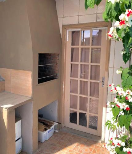 a room with a door and a window in a house at Casa cinza in São Lourenço do Sul