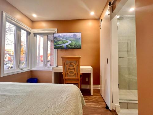 a bedroom with a bed and a bathroom with a shower at Newly Renovated Home in Toronto Near Subway in Toronto