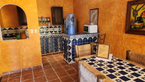 a kitchen with a table and a stove in a room at Casa Colonial Estate, Cozumel in Cozumel