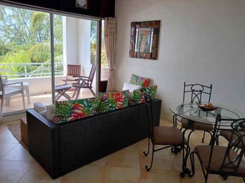 a living room with a couch and a glass table at Coral Lane Beach Apartments in Saint James