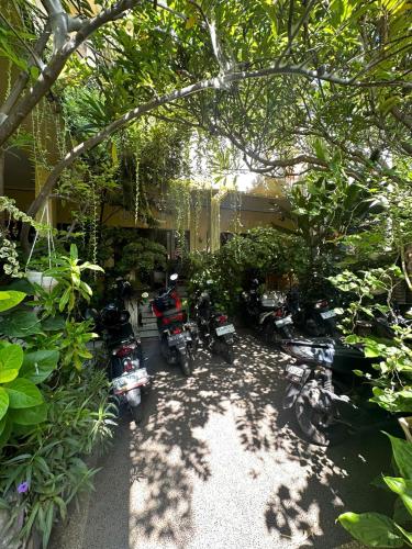 a group of motorcycles parked in front of a house at Sari Buana Bed & Breakfast in Kuta