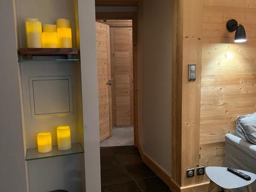 a room with a hallway with yellow candles on a shelf at Appartement Prestige 3 Pièces à Avoriaz - 5/7 Pers, Ski In/Out, Balcon Plein Sud, Équipements Haut de Gamme - FR-1-314-234 in Morzine