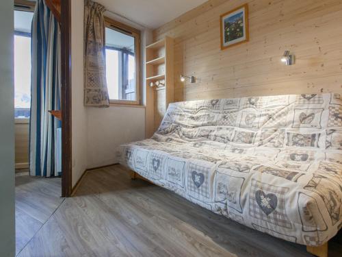 a bedroom with a bed in a wooden wall at Appartement Avoriaz, 2 pièces, 5 personnes - FR-1-314-264 in Morzine