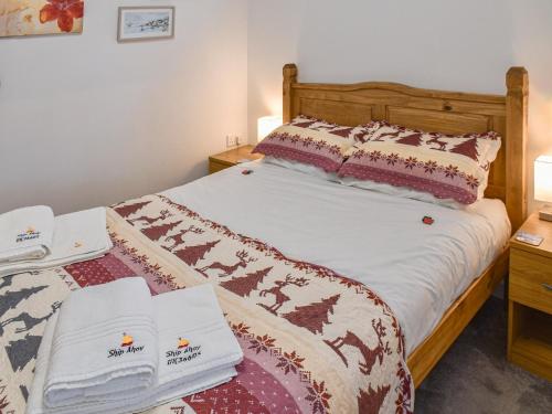 a bedroom with a bed with two towels on it at Ship Ahoy in Walcott