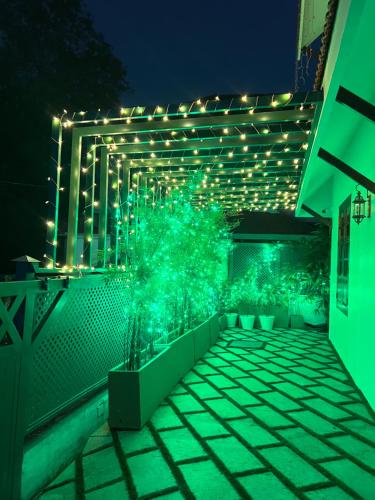 a patio with green lights on a building at night at SeaCoast Inn FortKochi in Fort Kochi