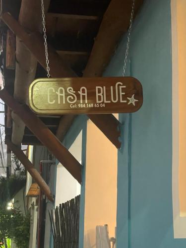 a sign for an asahi blue on a building at Casa Blue "HABITACION DELFIN" in Holbox Island