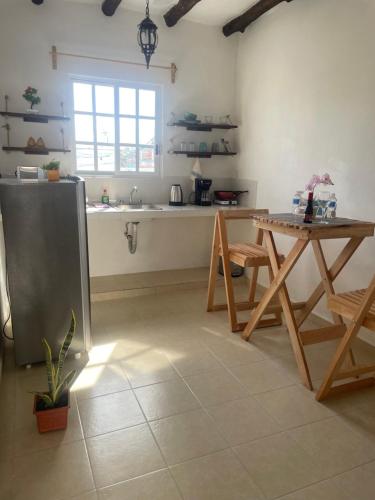 a kitchen with a table and a sink and a table at Casa Blue "HABITACION DELFIN" in Holbox Island