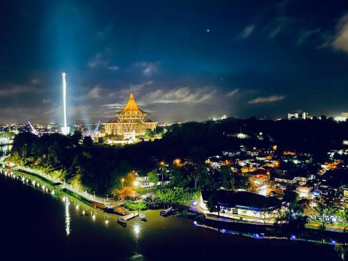 a view of a city at night with a building at Kuching City Center Riverbank Suites With Marvelous River View in Kuching