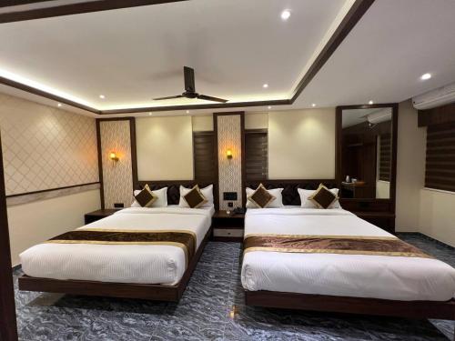 a hotel room with two beds in a room at Hotel Mangalore Stay INN in Mangalore
