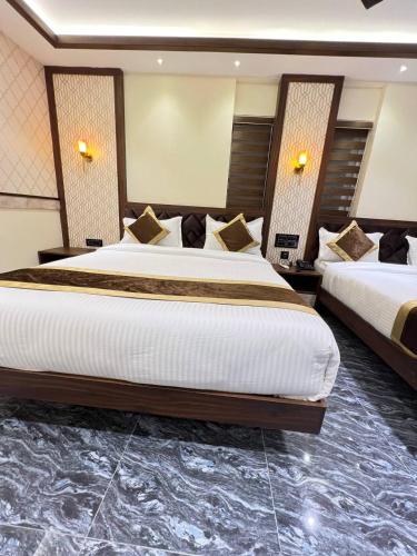 a hotel room with two beds in a room at Hotel Mangalore Stay INN in Mangalore