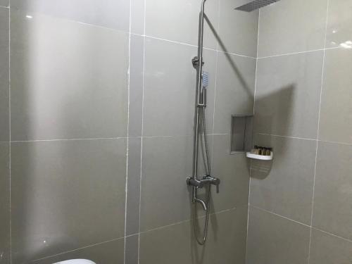 a shower with a glass door in a bathroom at Pohon Purba Resort & Restaurant in Labuan Lombok
