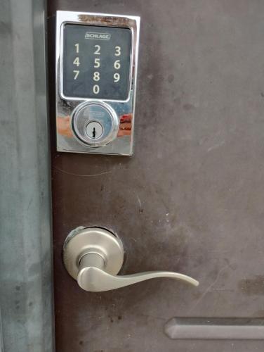 a clock on a metal door with a handle at DOLPHIN Maeva Residencial in Puerto Peñasco