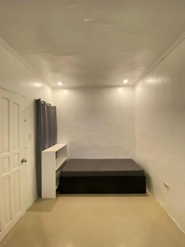 a room with a bed in the corner of a room at Casa Luna 4 by Angelito's in General Luna