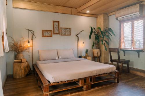 a bedroom with a bed in a room at TỊNH Retreat Phu Quoc in Phu Quoc