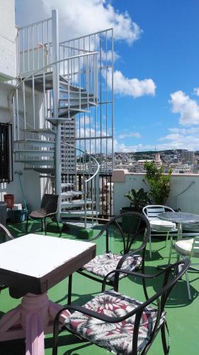 a balcony with chairs and a spiral staircase on a building at Hou heights - Vacation STAY 63951v in Naha