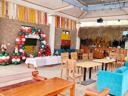 a restaurant with tables and a large christmas tree at Ha Giang Lotus Hostel Motorbikes and Tours in Ha Giang