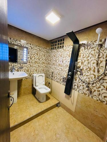 a bathroom with a toilet and a sink at BW Residence in Kalmunai