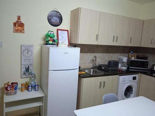 a kitchen with a white refrigerator and a dishwasher at Xylophagou Rest and Relax 3 Ayia Napa Larnaca 1 bedroom apartment in Xylophaghou
