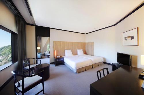 a hotel room with a bed and a desk at ANA Crowne Plaza Kobe by IHG in Kobe