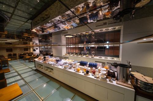 a restaurant with a counter with a lot of dishes at Best Western Jeju Hotel in Jeju