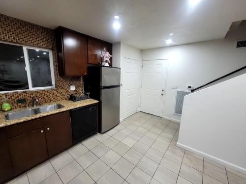 a kitchen with a sink and a refrigerator at 4 Bedrooms & 2.5 Bathrooms in LA in Los Angeles
