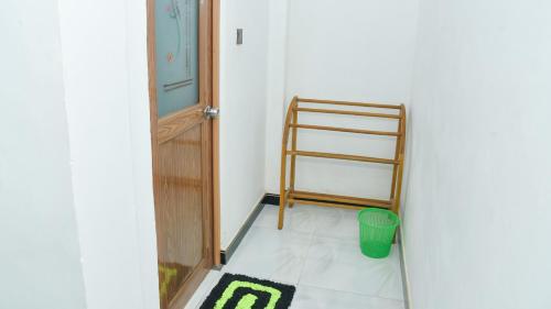 a room with a door and a ladder and a rug at Prem Nadee Homestay in Dambulla