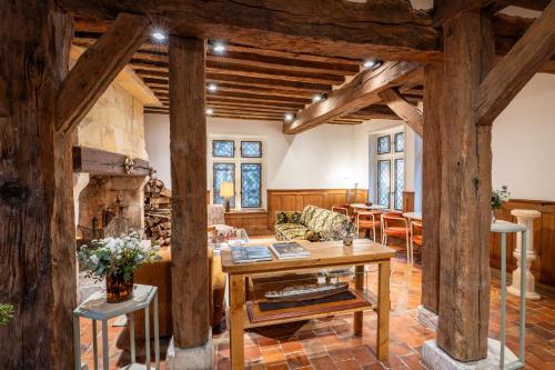 a living room with a table and a fireplace at L'Absinthe Hotel in Honfleur