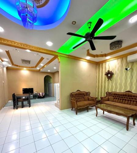 a lobby with couches and a ceiling with green lights at Melody D’Rimba Sandakan in Sandakan