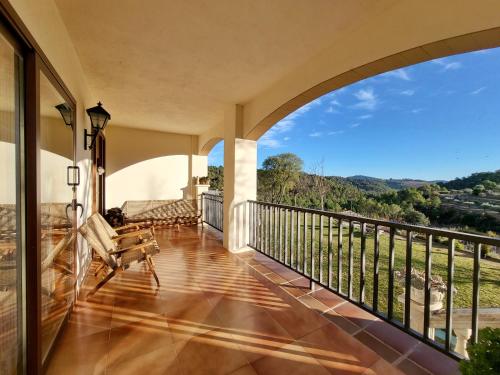 an indoor balcony with a view of the mountains at Casa Migjorn in Valls de Torroella