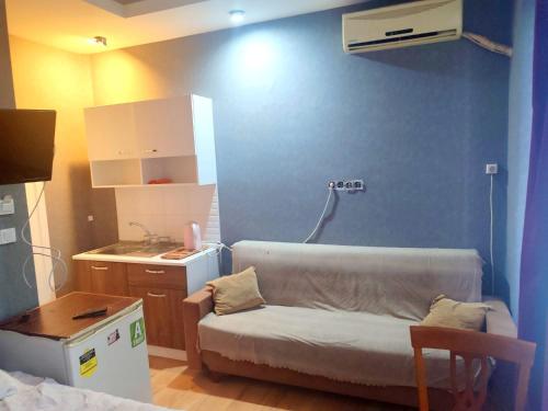 a small room with a couch and a kitchen at Family Hotel Taksim in Istanbul