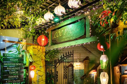 a restaurant with lights and a sign on the wall at Loc Phat Hoi An Homestay in Hoi An
