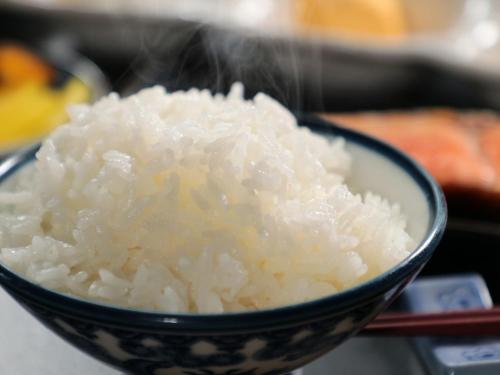 a bowl of rice sitting on a table at Business Ryokan Iroha in Minokamo