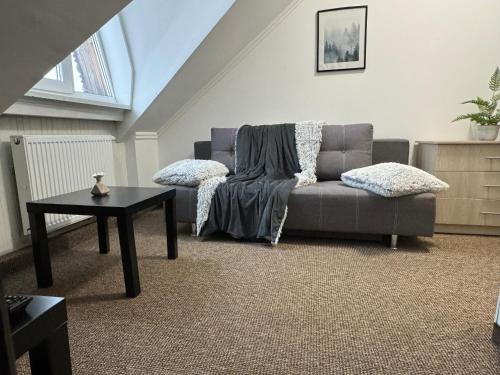 a living room with a couch and a table at Карпатський Затишок in Slavske
