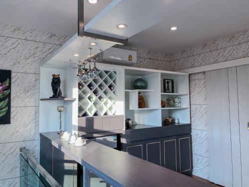 a kitchen with a counter top and a shelf at NanaH Tha Phae Private House in Chiang Mai