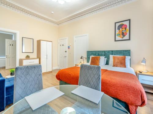 a bedroom with a bed and a glass table at Apartment Two - Uk44285 in Arbroath