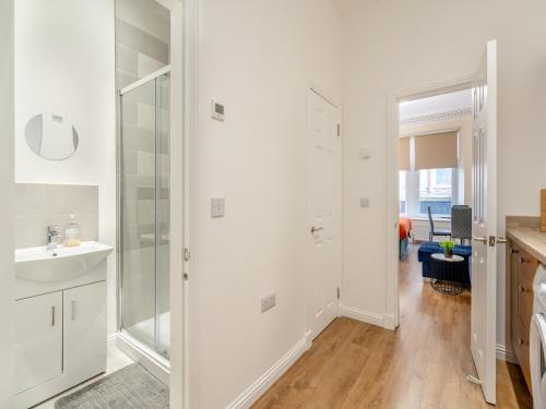a white bathroom with a shower and a sink at Apartment Two - Uk44285 in Arbroath