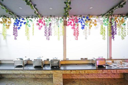 a table with a bunch of flowers hanging from the ceiling at JRD Luxury-Business Hotel in New Delhi