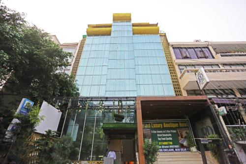 a tall building with glass windows on a city street at JRD Luxury-Business Hotel in New Delhi