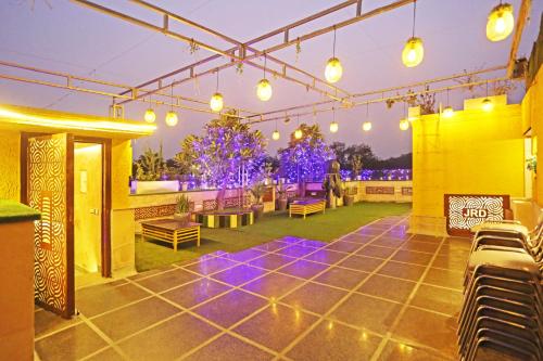a patio with chairs and lights on a building at JRD Luxury-Business Hotel in New Delhi