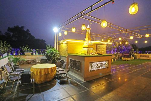 a patio with a table and chairs and lights at JRD Luxury-Business Hotel in New Delhi