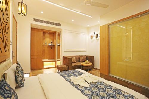 a hotel room with a bed and a bathroom at JRD Luxury-Business Hotel in New Delhi